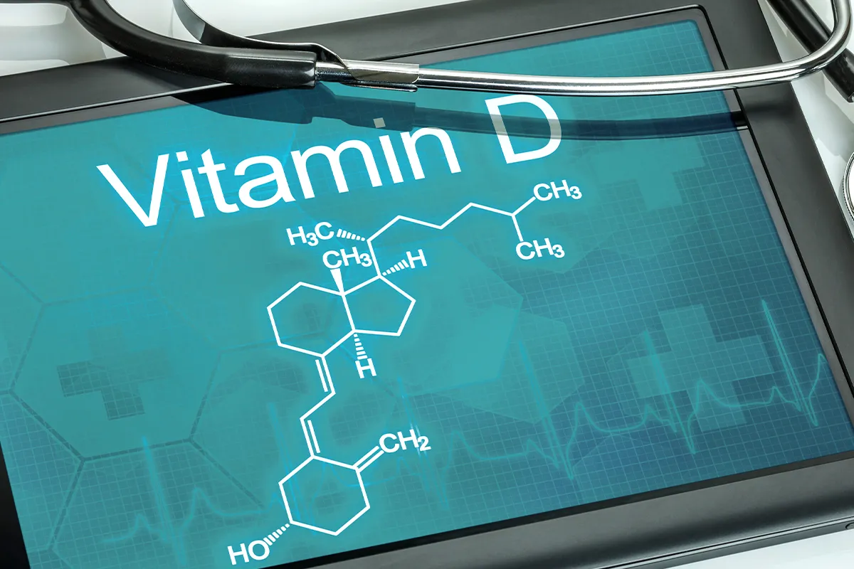 Vitamin D Molekül auf einem Pad mit einem Teil eine Stetoskop drüber